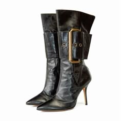 a pair of black leather boots with stiletto heels and a large buckle on the side. the boots are made of highquality leather and have a sleek, stylish design. the buckles add a touch of detail and sophistication to the boots. they are perfect for any occasion and can be dressed up or down.