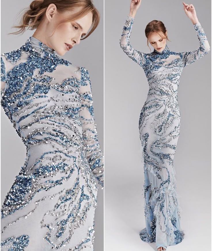 two images sidebyside showcase a woman modeling an elaborate, floorlength evening gown. the dress is predominantly light blue with silver embellishments in swirling, abstract patterns. it features a high neck or turtleneck design and long sleeves. the detailing includes intricate beadwork and sequins. in the fulllength image on the right, the model stands with her arms raised above her head. the image on the left is a closeup, providing a clearer view of the dress's texture and design around the neck and upper body. the dress seems to be made of a slightly sheer fabric that reveals glimpses of skin. the model has her hair styled in an updo. the overall aesthetic is high fashion, elegant, and couture.