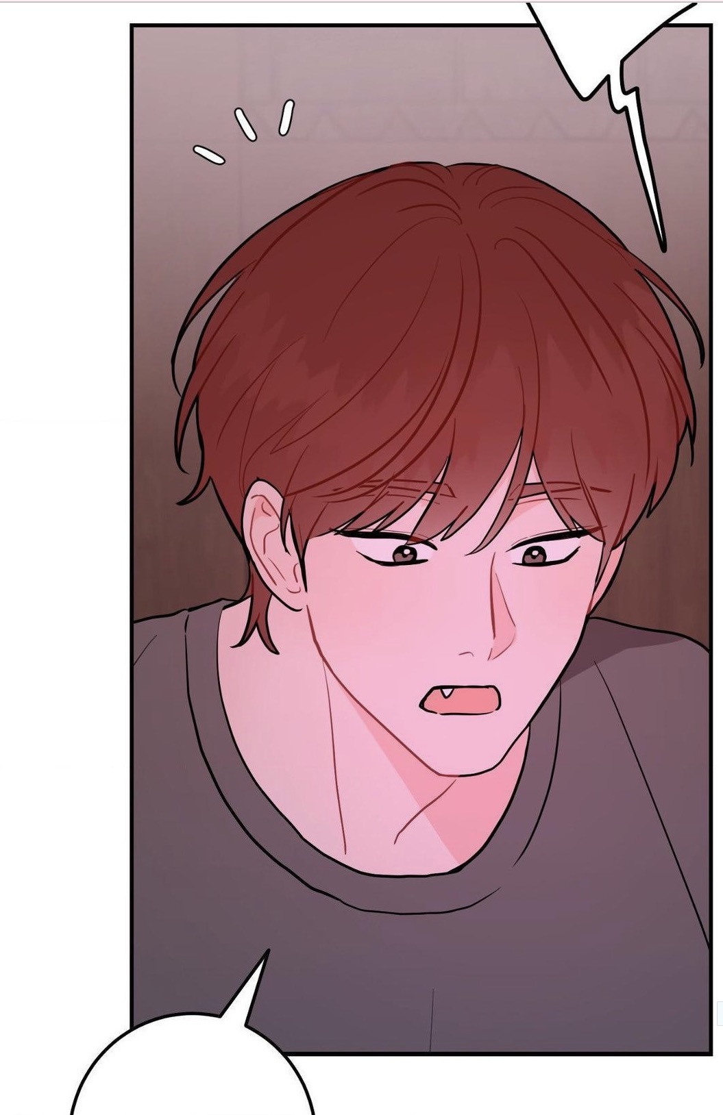 a closeup illustration from a manga or manhwa. a young man with reddishbrown hair is shown from the chest up. his expression is a mixture of surprise and possibly slight embarrassment; his cheeks are flushed.  he's wearing a dark gray or black shirt.  there is a speech bubble near the bottom and a smaller thought bubble above his head. the art style is soft and features pink tones.
