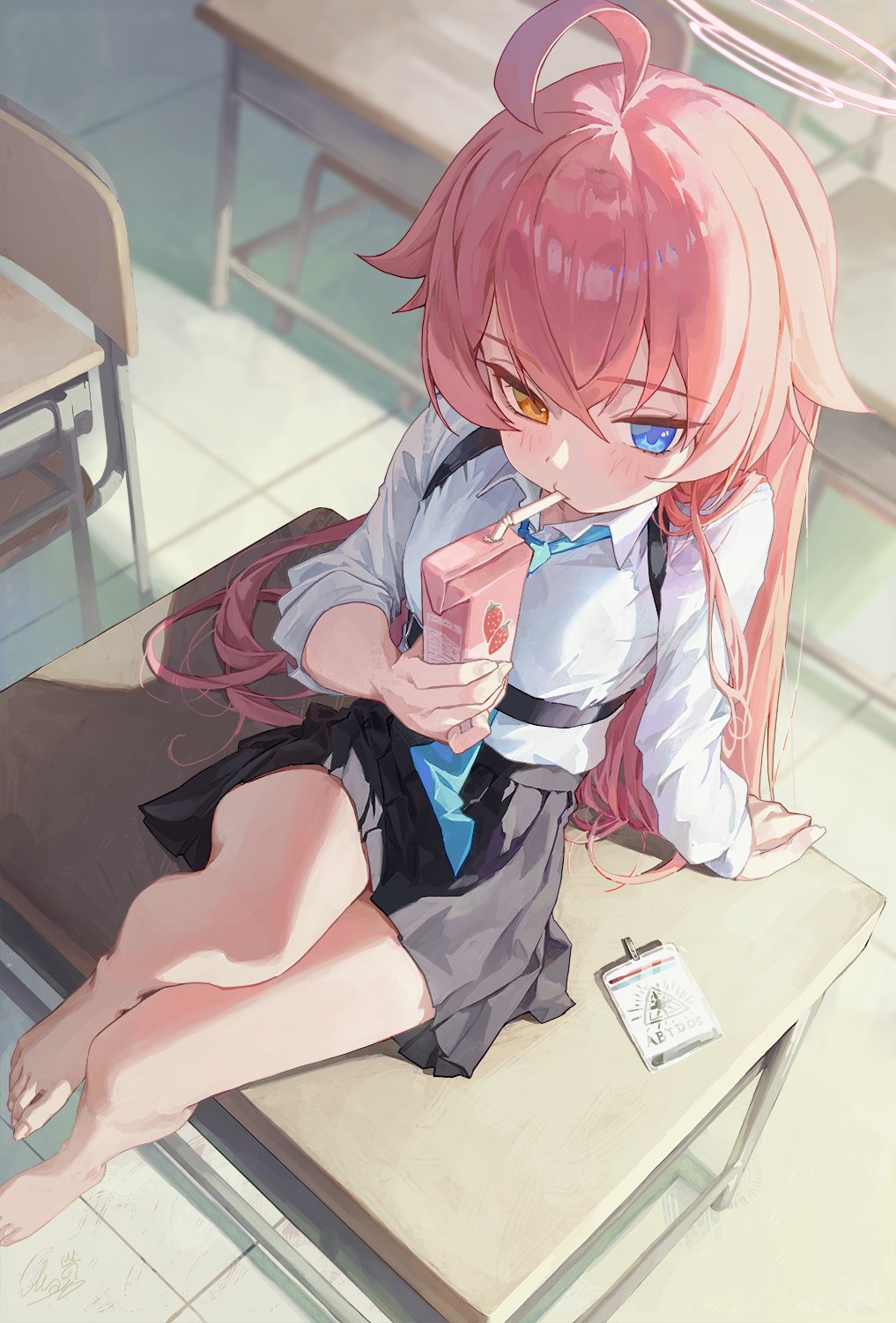 the image is a digital illustration of an anime girl with pink hair and heterochromia (one blue eye and one yellow eye). she is wearing a school uniform consisting of a white shirt, a dark gray pleated skirt, and a light blue tie. she is sitting on a desk in a classroom, barefoot, and drinking juice from a small pink box with a straw.  the art style is soft and pastel, with a focus on the character's cute features and expression.  there is a notepad or small clipboard next to her on the desk. the overall ambiance is peaceful and slightly dreamy.