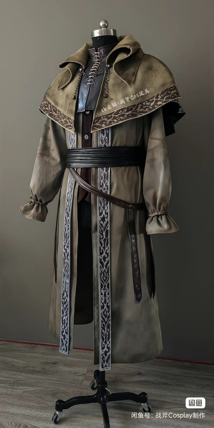 a close up image of a person in a cosplay costume that appears to be inspired by the fictional character "the hunter" from the video game bloodborne. the outfit is a long, green robe with a hood and intricate patterns.  the figure is wearing a belt with a buckled leather strap and another strap that hangs down with a decorative metal piece on the end. the individual's face is hidden from view.