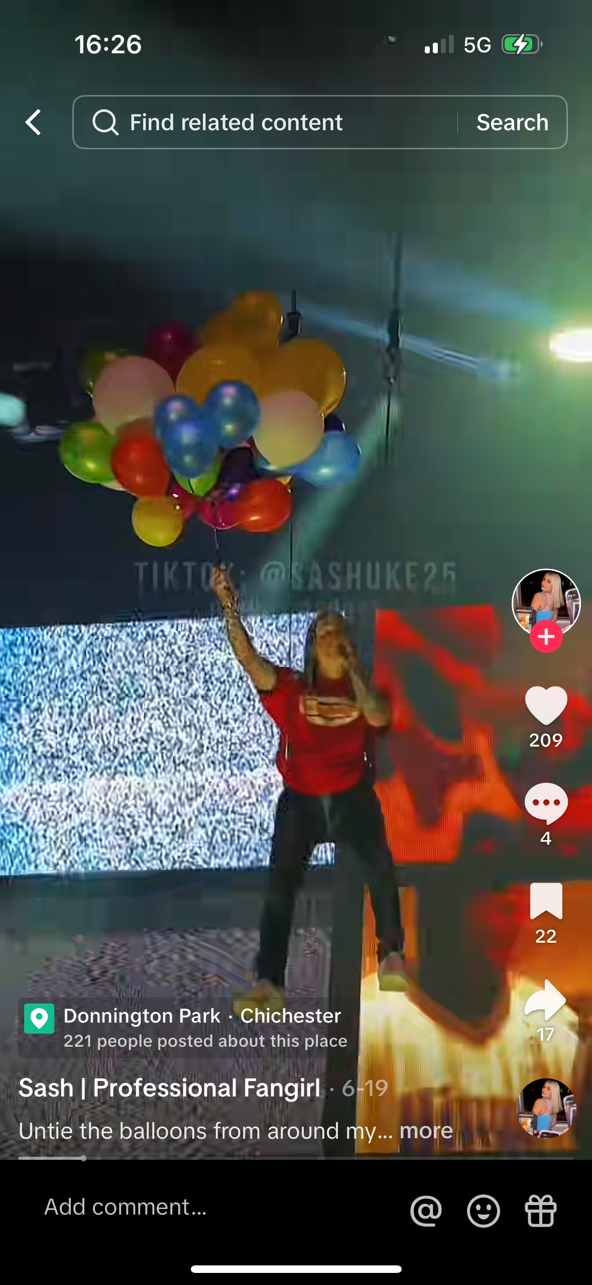 this image shows a girl in a red shirt holding a large bunch of balloons and smiling. the caption says "untie the balloons from around my..." which suggests that she is playing a game or challenge. the image is from a tiktok video and shows the heart, comment, and share buttons, as well as the number of views and likes.