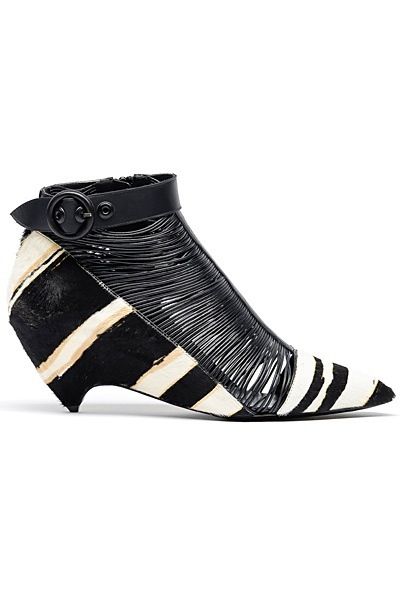 a pair of women's black and white zebra print ankle boots with a kitten heel.  the boots are made of calf hair and feature a leather strap with a buckle at the ankle. the upper part of the shoe has a cutout design with black leather straps creating a caged effect. the heel is a low wedge. the shoes are presented against a white background.