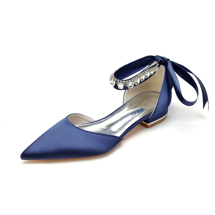a pair of blue satin low heel bridal shoes with rhinestone ankle straps and a bow. the shoes are elegant and formal, perfect for a wedding or other special occasion. they are also very comfortable to wear, with a low heel that won't tire your feet.
