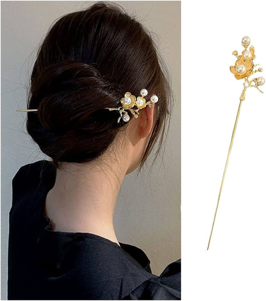 the image showcases a woman with a stylishly done bun, adorned with a golden hair stick. the hair stick features a delicate design of golden flowers and pearls, adding a touch of elegance to her hairstyle. the soft, natural lighting enhances the warm tones of the image.