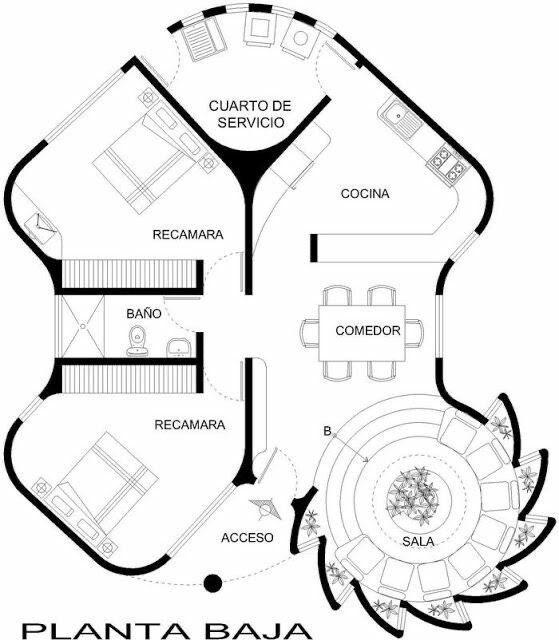 this image shows a detailed floor plan of a house, labeled "planta baja". the plan includes various rooms such as "recámara" (bedroom), "baño" (bathroom), "acceso" (entrance), "sala" (living room), "comedor" (dining room), "cocina" (kitchen), and "cuarto de servicio" (service room). the floor plan indicates the placement of furniture like beds, a toilet, a sink, a dining table, and sofas. the layout is unique, with curved walls and an interesting arrangement of rooms, especially the circular "sala" with seating around a central feature. there are stairs leading to the upper level.