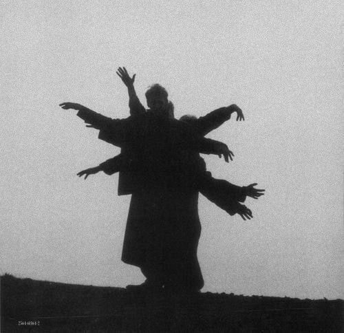 three figures are silhouetted against a plain background. they are posed in a contemporary dance position. their limbs are extended in a variety of positions, creating a dynamic and abstract image.  the use of black and white creates a strong contrast between the figures and the background, emphasizing the shapes and forms of their bodies.