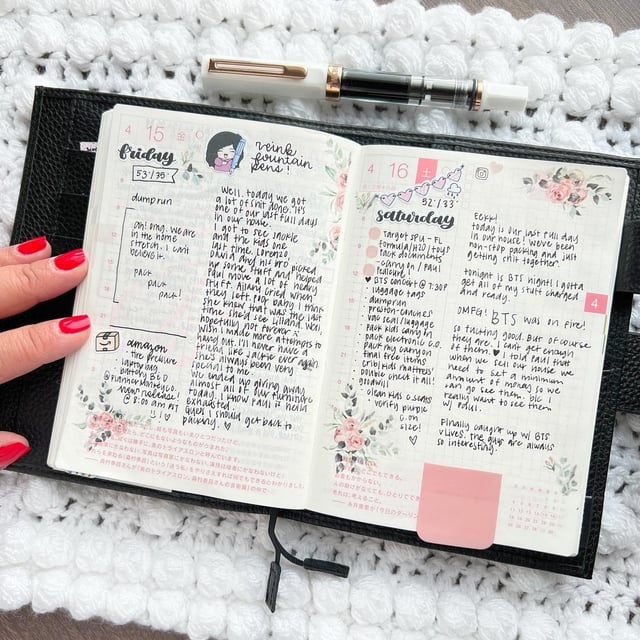 the image shows an open bullet journal, displaying two facing pages. the left page is titled "friday," and details daily activities like a "dump run," amazon orders, and personal reflections on a busy day involving family and moving. the right page is titled "saturday," and is focused on preparations for a bts concert, including packing, todo lists, and excited anticipation.  both pages are meticulously decorated with pink floral stickers and handwritten text. a black leather journal cover and a pair of fountain pens are also visible, enhancing the overall aesthetic of meticulous organization and personal journaling.
