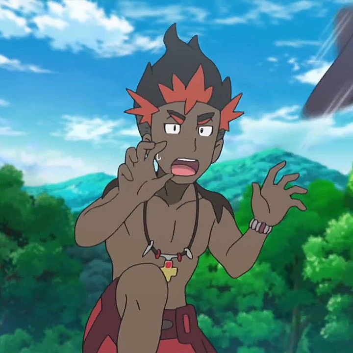an anime style cartoon image of a male character. he has red and black hair with brown skin. he is wearing a brown necklace and a red and black loincloth. the character has a panicked look on his face with his mouth open and his hands raised in a gesture of fear or surprise. the background is a lush green forest with mountains in the distance and blue skies. the character appears to be looking off to the left of the image as if something has startled him. the image is a digital illustration in anime style.