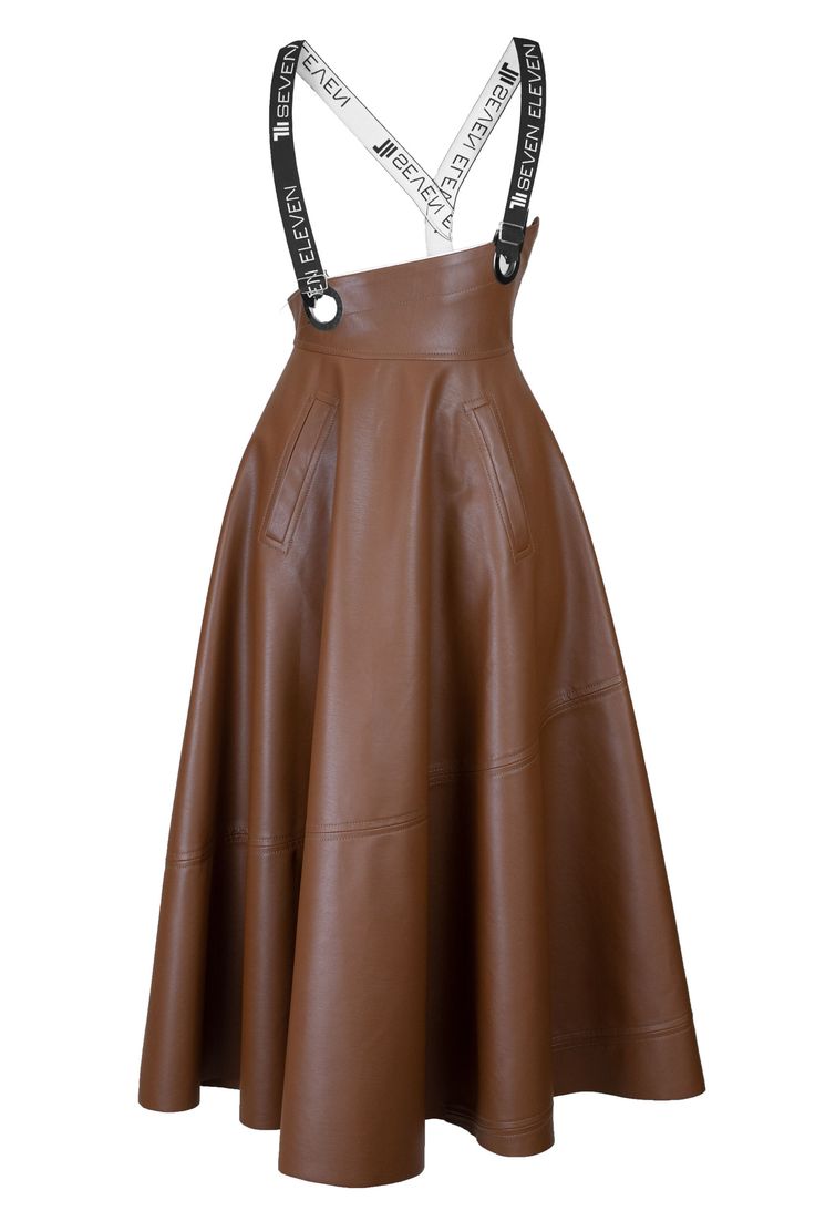a brown leather midi aline skirt with suspenders with "seven eleven" branding. the suspenders attach to the skirt with metal rings. the skirt has seam detailing and pockets.