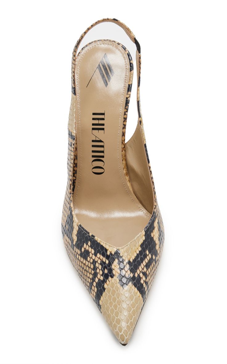 a closeup, overhead shot of a single the attico pointedtoe slingback high heel shoe. the shoe is made with a snakeskin pattern in a color palette of tan and dark brown/black. the inner sole is tan and features the logo of the brand "the attico" vertically aligned. the heel is a thin, stiletto style, and the shoe has a slingback design. the background is white.