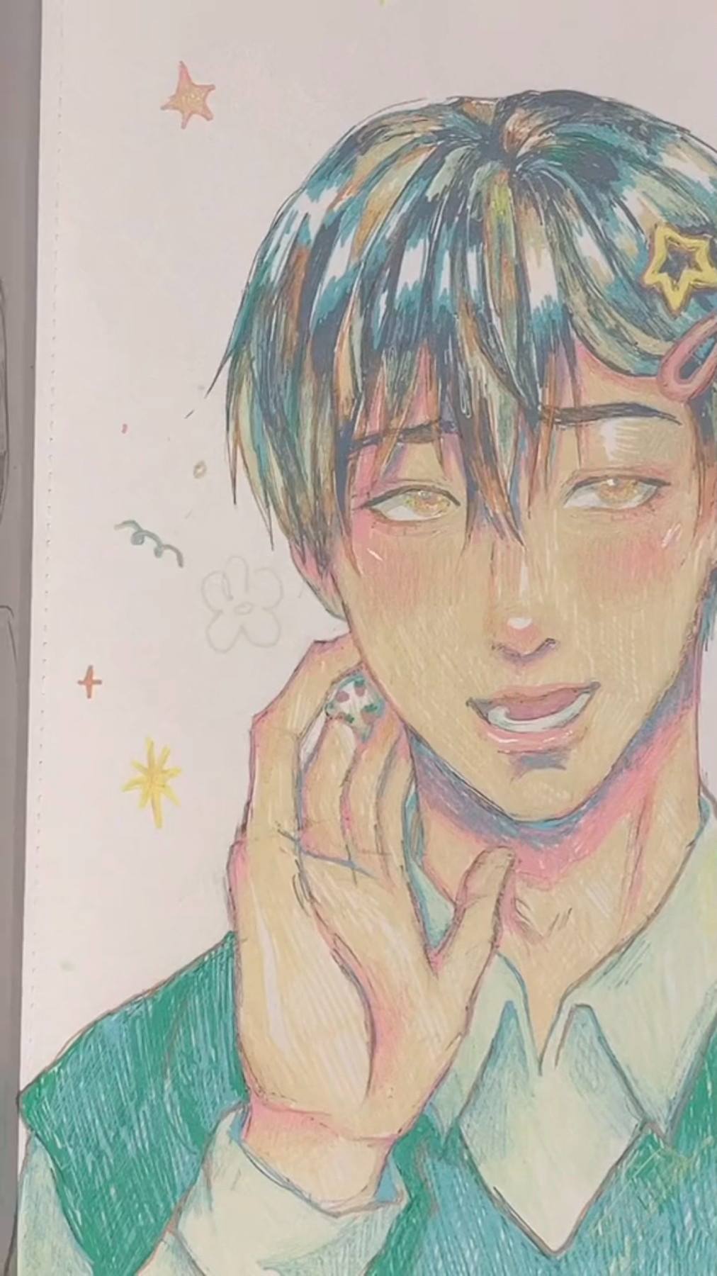 this is a colored pencil drawing of an anime boy. he has short, blue hair and a happy smile on his face. he is wearing a green sweater and a white shirt. the boy has a pink blush on his cheeks and his eyes are a warm brown color. his right hand is up to his cheek and he's got a sweet, friendly smile on his face. the drawing has been done with colorful pencils on white paper and there are stars and flowers drawn around the boy's head.  the drawing is very well done and the boy looks very cute and cheerful.