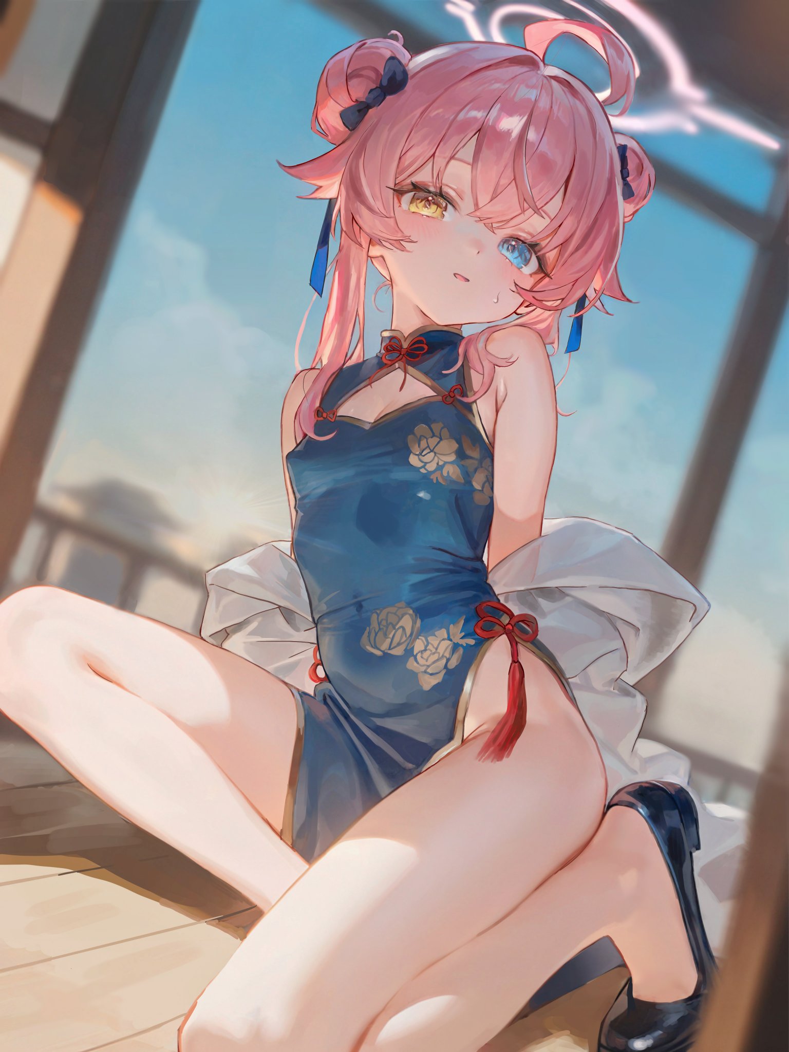 the image is a digital illustration of a young anime girl with heterochromia (one blue and one yellow eye). she has long, pink hair styled in two buns on the top of her head, adorned with small black bows. she's wearing a beautiful blue cheongsam (qipao) with floral patterns, the dress is sleeveless and features a side slit. the girl is sitting on a wooden surface, possibly a porch, with sunlight illuminating her legs and creating shadows. she is positioned in a relaxed but elegant pose, partially draped with a white garment. the background is a blurred outdoor scene suggestive of a warm, sunny day. the overall style is evocative of anime and manga, characterized by large, expressive eyes and a soft, slightly idealized representation of the human figure. the art style is polished and detailed, indicative of professional digital painting or illustration work.