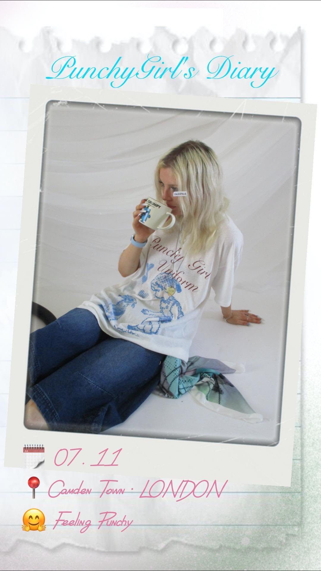 a polaroidstyle image depicting a diary entry. the top of the image displays "punchy girl's diary" in a stylized font. the main photo shows a blonde girl sitting on the floor, wearing a white tshirt with the words "punchy girl uniform" printed on it, blue jeans, and a light blue scarf. she's holding a mug and appears to be in camden town, london on july 11th, as indicated by the text at the bottom. the overall aesthetic is vintage and captures a personal, stylish moment in the girl's life.