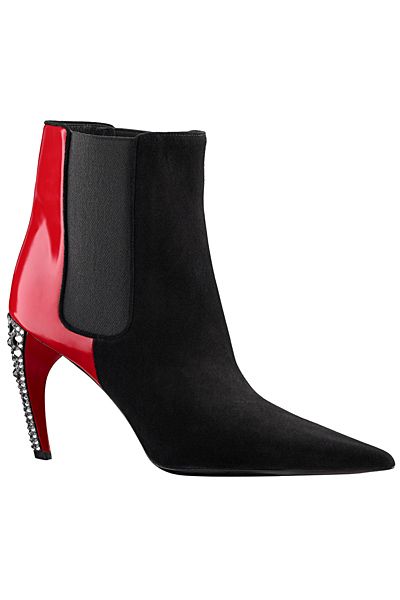 a single black and red highheeled boot with rhinestones is shown against a plain white background. the boot has a black body, a red back heel, and rhinestones along the heel edge. the boot is angled slightly to the left.