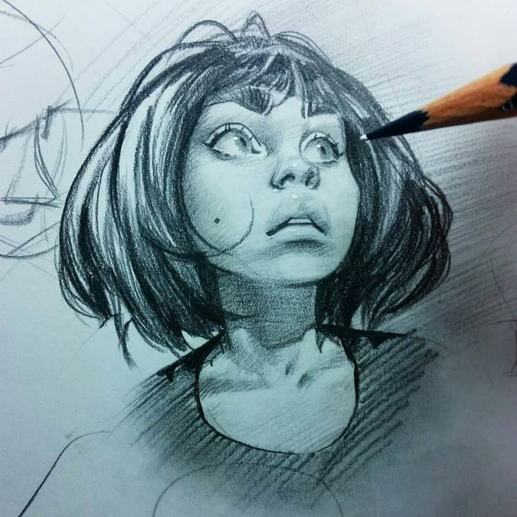 a pencil drawing of a young woman with a bob haircut looking up, with an artist's hand holding a pencil near her face. the drawing shows detailed shading and a realistic style.
