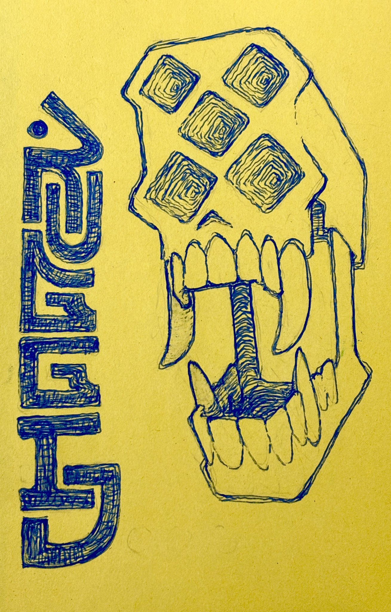 the drawing is of a stylized skull with a video game controller superimposed on the face. the upper teeth are drawn as fangs. the drawing appears to be made with blue ink on yellow paper. to the left of the skull is an abstract design in blue ink that could represent a word or ideogram.
