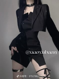 a woman is wearing a black dress with a jacket over it and a garter on her leg. she is looking at the camera.