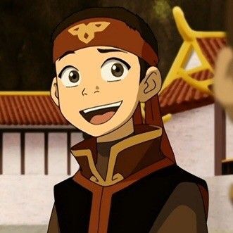 a young boy, who appears to be an animated character, smiles at the camera. he is wearing a red, black, and gold outfit and has a headband with a swirl design on his head. he is standing outdoors.