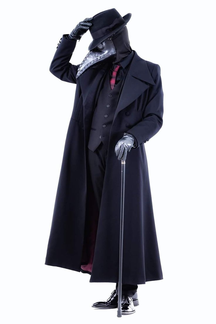 a person dressed in a plague doctor costume stands holding a cane. they are wearing a long black coat and a mask with a beak. they are standing against a white background.