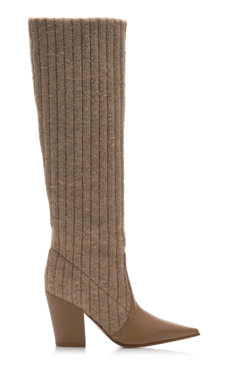 a pair of women's kneehigh boots are shown on a white background. the boots are made of a ribbed knit fabric in a beige or taupe color. the upper part of the boot is knit, while the lower part and heel are made of matching leather. the boots have a pointed toe and a block heel. the style is elegant and sophisticated, suitable for fall or winter.