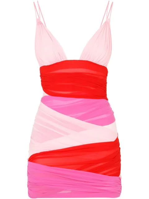 a vibrant colorblocked mini dress. the dress features thin spaghetti straps and is composed of shades of pink and red. the fabric appears draped and gathered for a ruched effect.