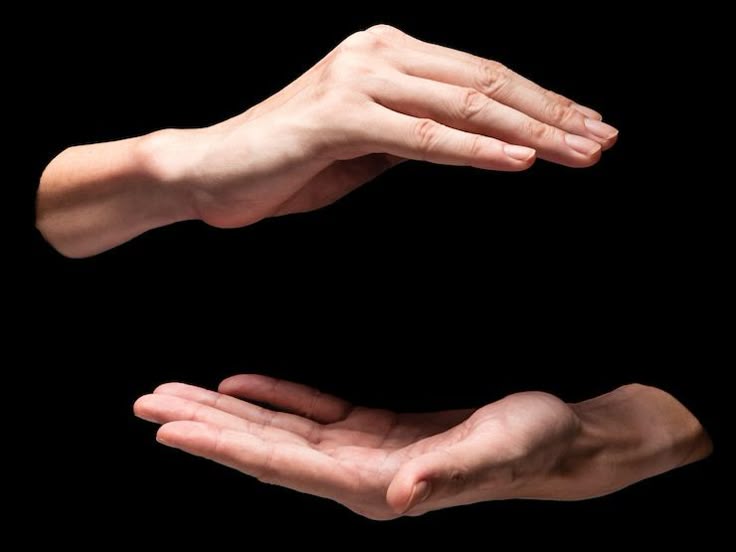 two hands are shown against a black background. the top hand is positioned above and angled downwards, as if shielding or protecting. the bottom hand is below, palm open as if receiving or offering. the hands are isolated with nothing else in the frame.