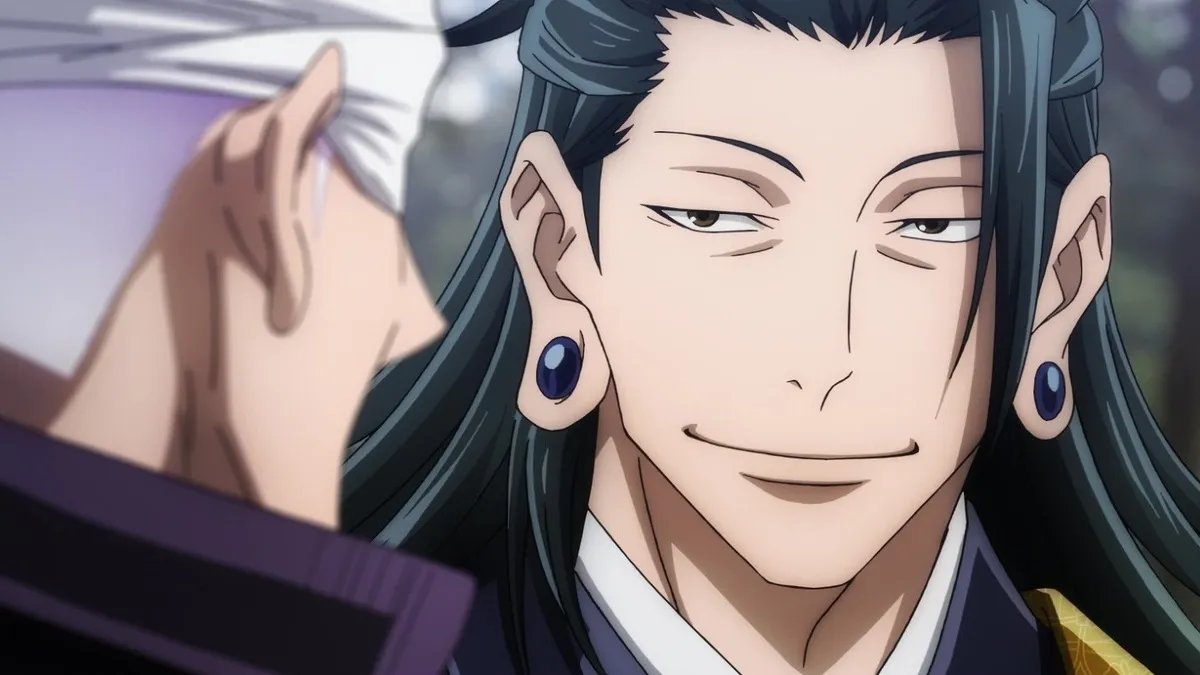 this is a close up of an anime male character with long black hair and blue earrings. he's smiling with a hint of mischief in his eyes. the person behind him is blurred out.  the image is taken from the side.