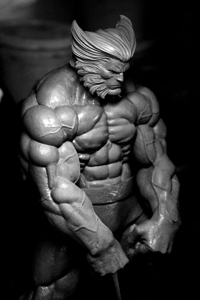 a black and white photograph of a highly detailed sculpture of the superhero wolverine. the sculpture is muscular and posed in a dynamic stance. the lighting is low key and dramatic, highlighting the musculature and details of the sculpture.