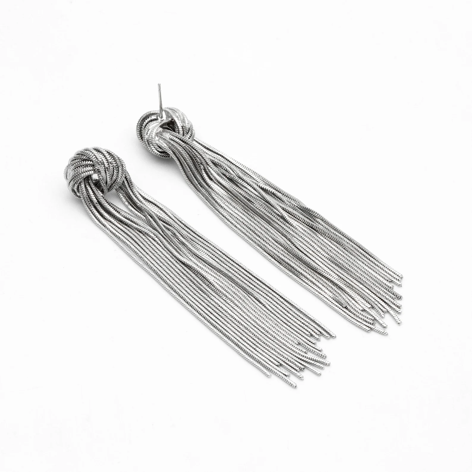 a pair of silver dangle earrings with a knot design and long chains. the earrings are shown on a white background.