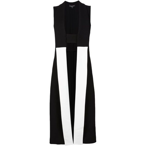 the image shows a black and white sleeveless long vest. the vest has a collared neckline and an open front. the design features a geometric pattern, with black and white panels creating a striking contrast. the overall style is modern, minimalist, and elegant, suitable for formal occasions.