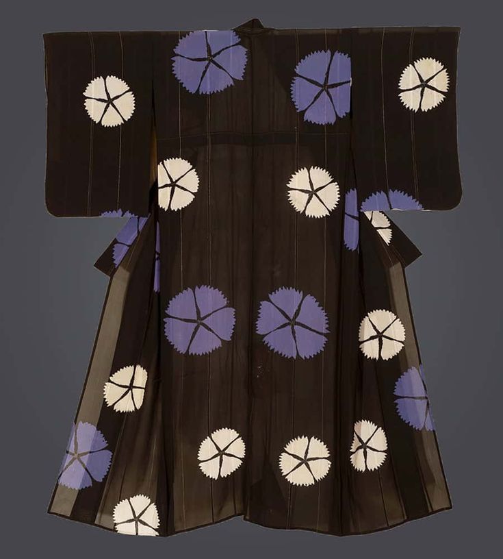 a black kimono with a floral pattern consisting of white and lavenderblue flowers is displayed against a neutral background. the garment is spread out to showcase its design and full shape, including the sleeves and side panels.