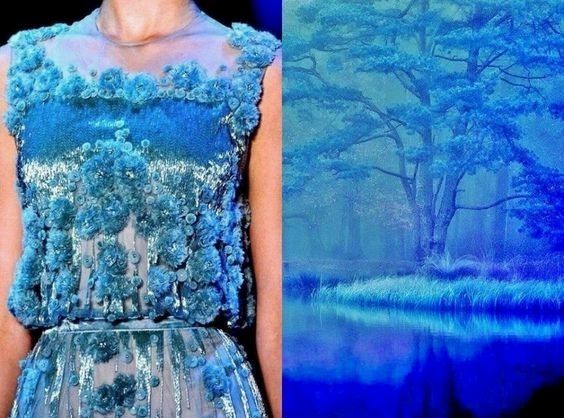 a woman in a stunning blue gown stands against a backdrop of a dreamy, ethereal forest. the dress features intricate floral details and a shimmering fabric, making it a true showstopper. the forest scene adds a touch of enchantment and magic to the image, highlighting the ethereal quality of the woman's attire. the image combines the beauty of fashion with the allure of nature, creating a truly captivating scene.