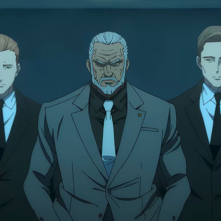 three men in suits stand in a dimly lit room. the man in the center is older, with gray hair and a beard. he has a serious expression on his face. the two men on either side of him are younger and appear to be his bodyguards. they are all looking directly at the viewer.