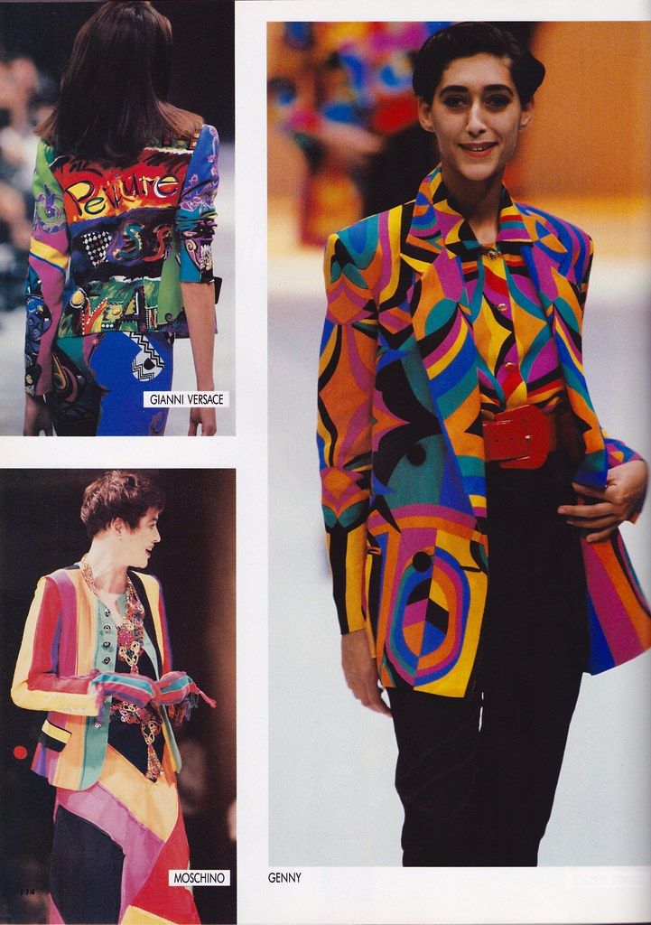 the image shows three fashion models wearing colorful patterned jackets on a runway. one model, labeled "gianni versace", is seen from the back wearing a jacket with vibrant colors and bold designs, including the word "peinture". another model, labeled "genny", is wearing a bright, geometric pattern jacket with black pants and a red belt. the third model, labeled "moschino", is wearing a colorful striped jacket and matching outfit.