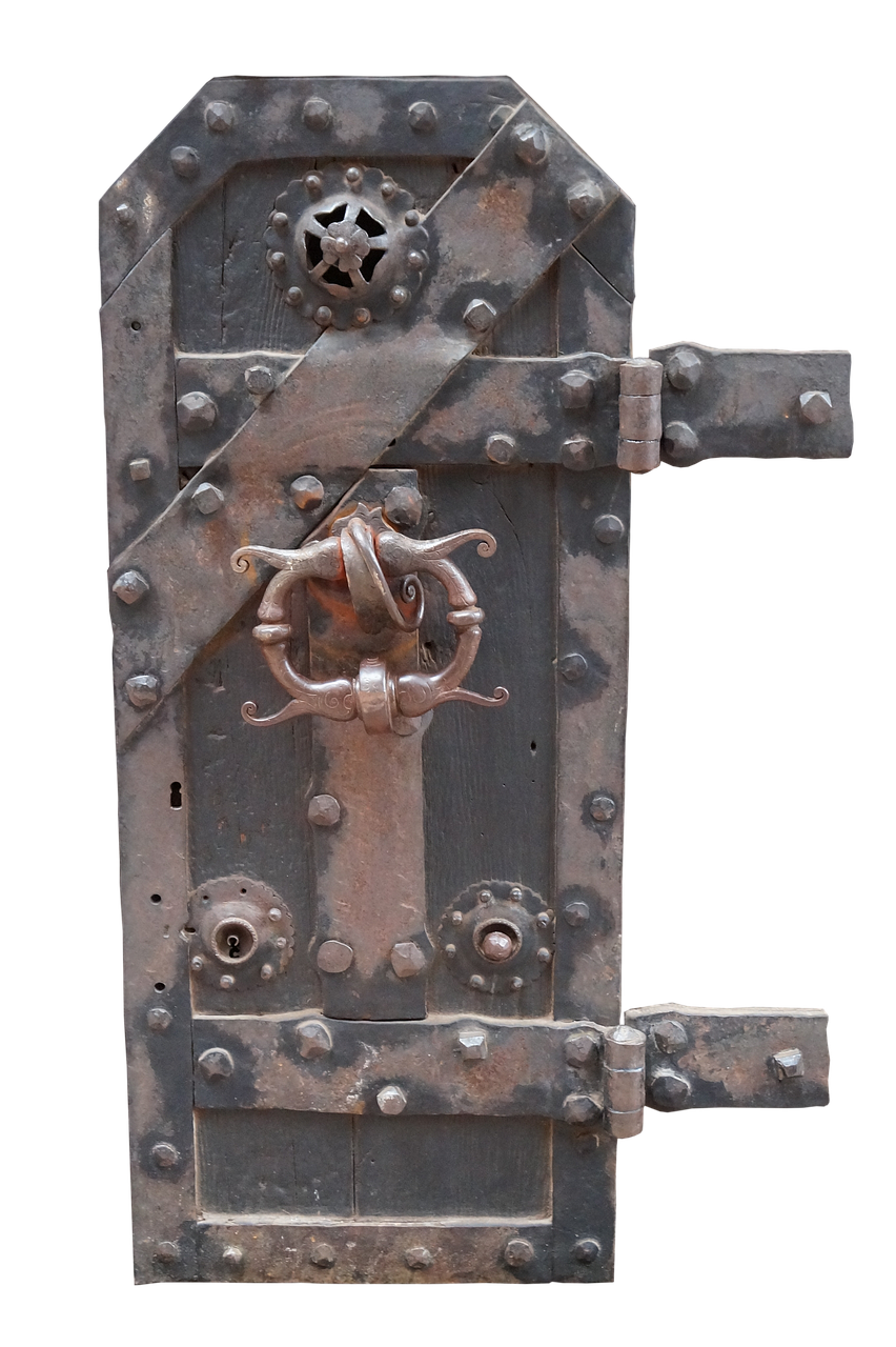 the image shows a medieval wooden door reinforced with iron. the door is black and heavily studded with rivets. iron bands cross the door diagonally and horizontally, adding to its robust appearance. a decorative iron handle is prominently placed in the center, and there are multiple locks and bolts securing the door. the background is black, highlighting the details of the door.