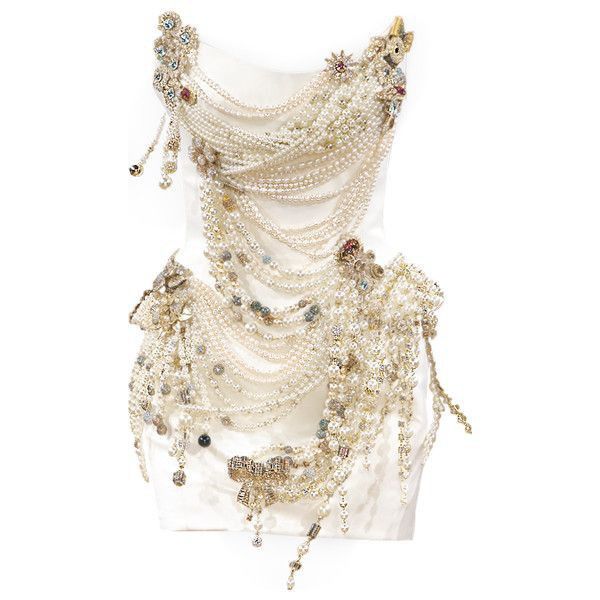 the image showcases a white dress or gown lavishly adorned with layers of pearls, beads, and jeweled embellishments. the design is intricate, featuring multiple strands of pearls cascading down the front of the garment. decorative elements like floral motifs and ornamental details are visible throughout, creating a luxurious and couturelike appearance. the overall aesthetic suggests high fashion and elaborate ornamentation.