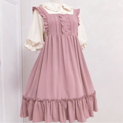 a pink lolita dress with ruffles and a white collar is shown on a mannequin.