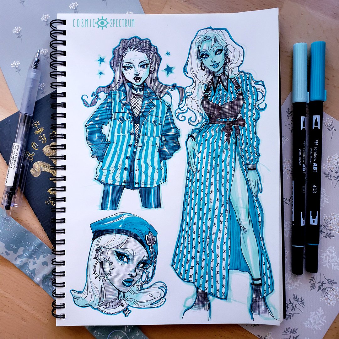 the image shows a sketchbook page featuring three fashion illustrations of stylized female characters.  the characters are drawn in a graphic, almost animeinfluenced style, with bold lines and detailed clothing.  they are dressed in various turquoise and white striped garments: a jacket, a dress, and a beret. the art is rendered in shades of turquoise and blue ink, likely using tombow abt markers, as two of these markers are visible next to the sketchbook. the sketchbook itself is labeled "cosmic spectrum" in the upper left corner. the background includes a portion of a notebook and some decorative floral elements.  the overall style is vibrant and modern.