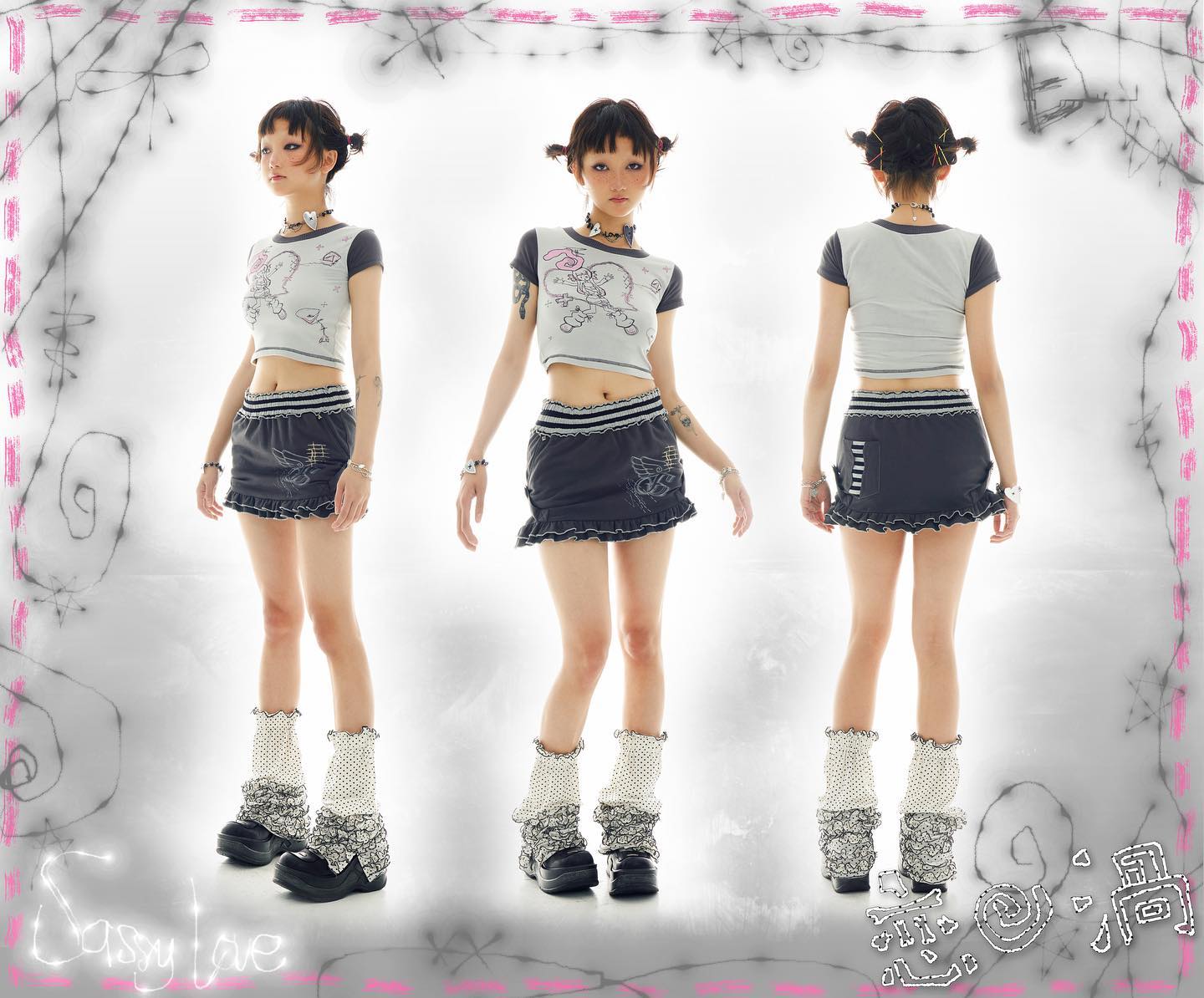 the image showcases a young asian woman modeling a complete outfit from the brand "sassy love." the outfit includes a shortsleeved grey graphic tee, a dark grey ruffled mini skirt with details, and white patterned socks paired with chunky black platform shoes. the model is depicted in three different poses: front, side, and back, providing a complete view of the clothing.  the backdrop is simple white, with a decorative pink border featuring scribbled drawings. the overall style is reminiscent of kawaii, y2k, alternative, or grunge fashion aesthetics.
