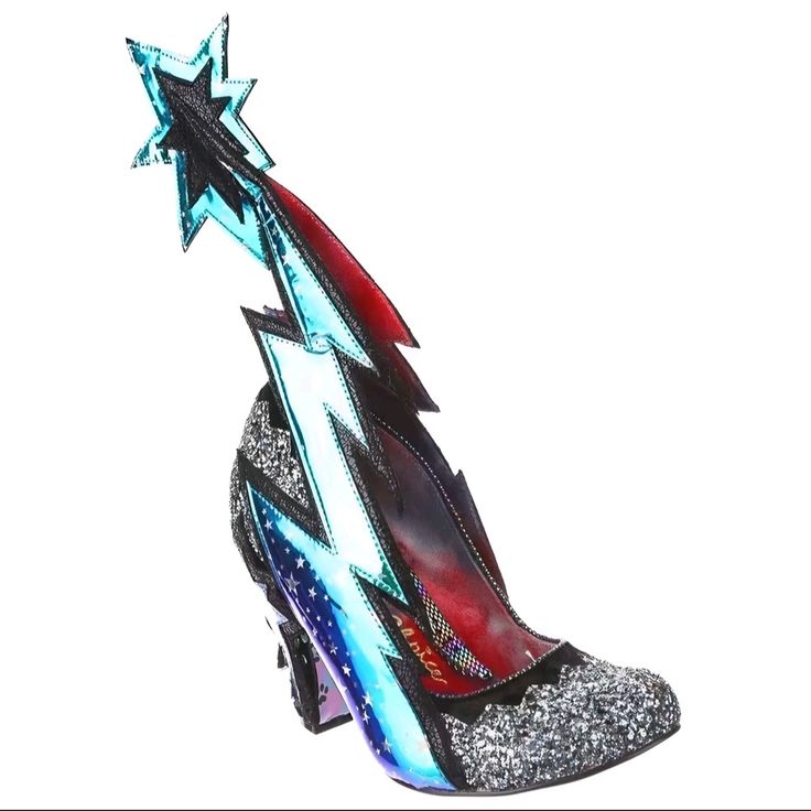 a single, highheeled shoe sits against a white background. the toe and heel are covered in silver glitter. a lightning bolt design is featured on the side in blue and metallic silver, outlined in black trim. the heel has a design of stars. above the heel a starshaped design in blue, silver, and black shoots upward. the inside of the shoe is a dark red.