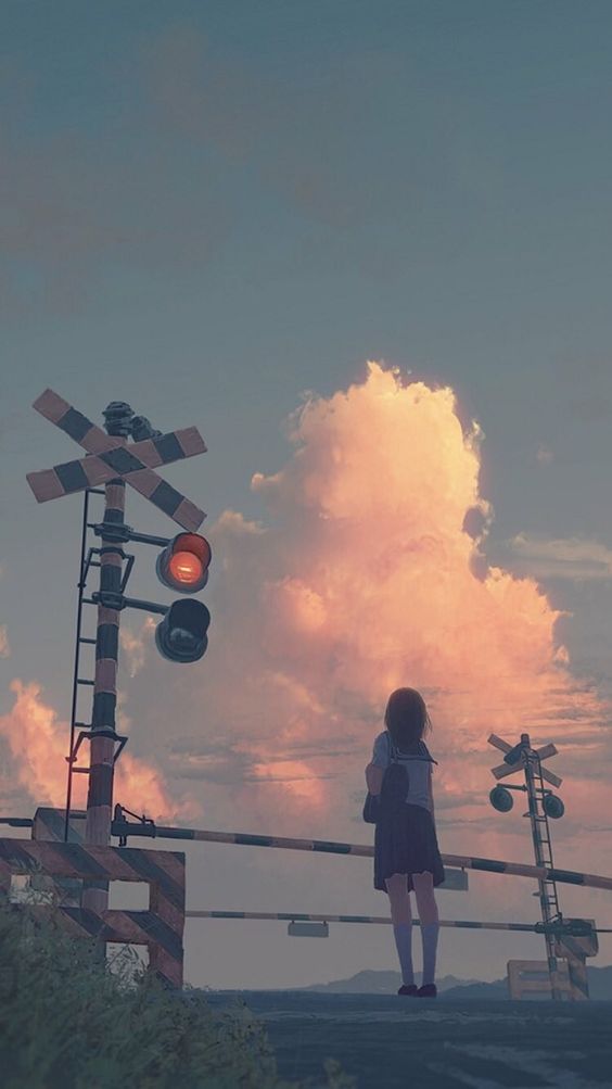 a young girl in a school uniform stands at a railroad crossing, her back to the viewer. she's gazing towards a beautiful sunset sky filled with pink and orange hued clouds. the warm evening light creates a serene and contemplative atmosphere.  the scene evokes a sense of peace and solitude.