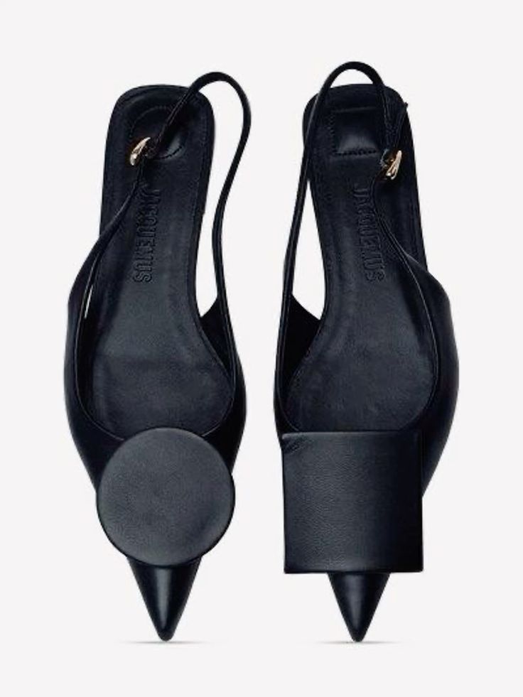 a pair of black leather women's heeled shoes with pointy toes and a unique design. the shoes are from the brand "jacquemus" and have a sleek, modern look. the shoes are perfect for a special occasion or for adding a touch of sophistication to any outfit.