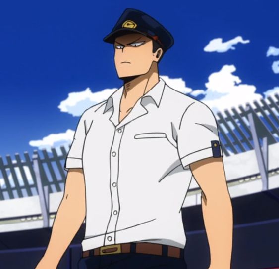 a man in a train conductor's uniform is standing with a serious expression on his face. he has short, dark hair and a muscular build. he is wearing a white, shortsleeved, buttonup shirt with a brown belt, navy blue pants, and a navy blue train conductor's hat with a gold emblem. the background of the image is a bright blue sky with a few white clouds and the top of a chainlink fence.