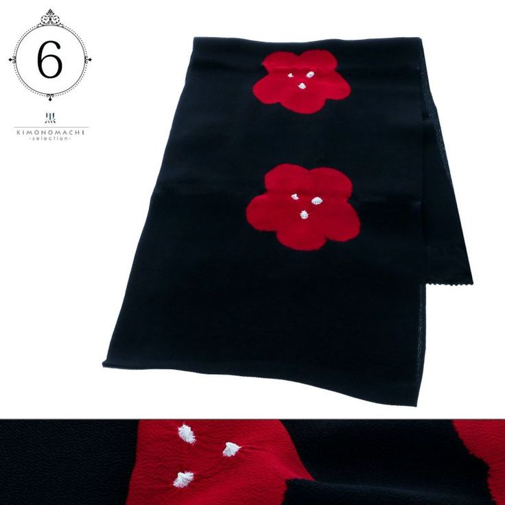 a black obi with two red flower patterns is displayed in the image.