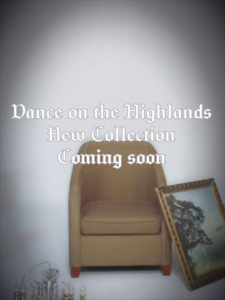 the image shows a tan armchair sitting in a room with a white wall.  there's a goldframed picture leaning against the chair.  the text overlay announces a "dance on the highlands new collection" is "coming soon".  a crystal chandelier is partially visible in the bottom left corner. the overall style suggests a fashion or home goods advertisement.