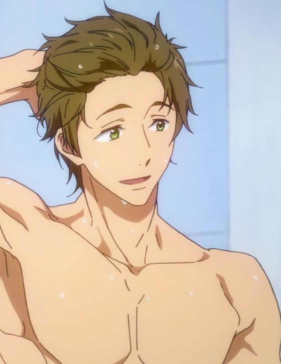 a young man with brown hair and green eyes smiles as he stands shirtless in the shower with water droplets on his body.