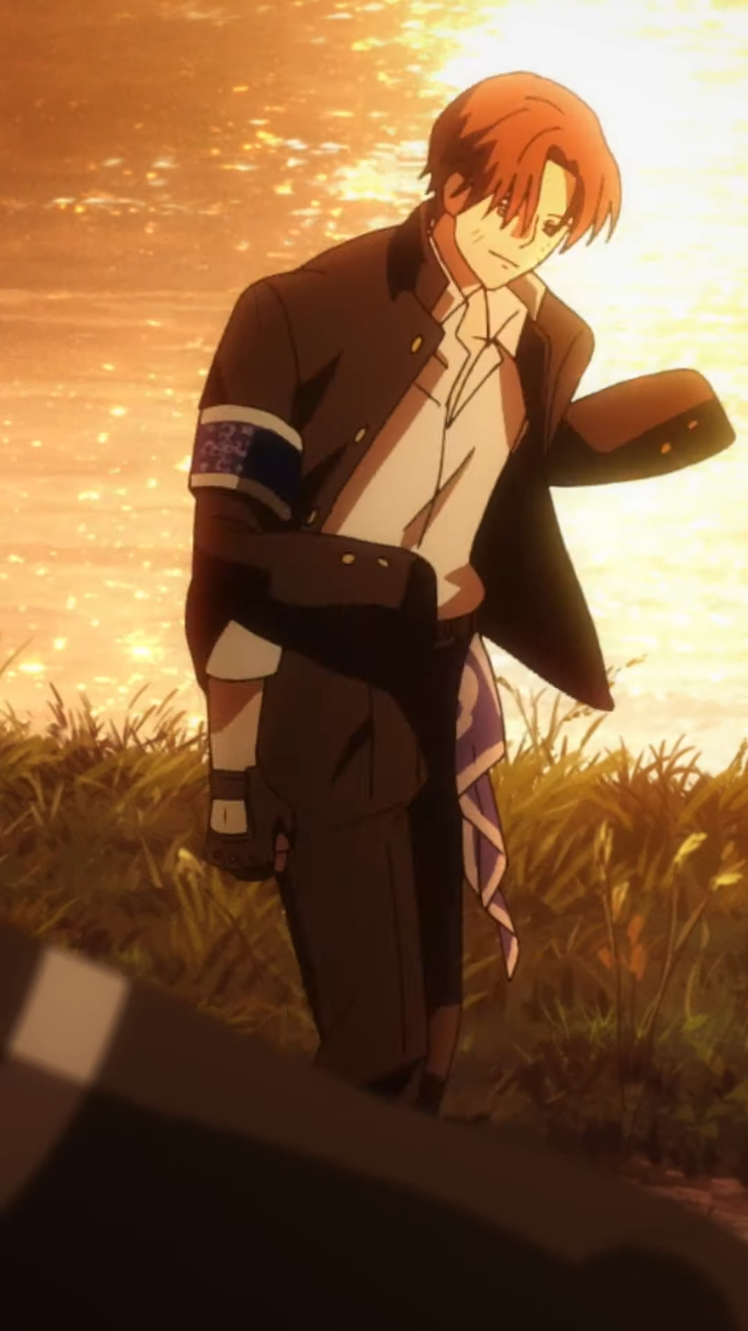 a young man with reddish hair and a determined look, is shown walking through a field of tall grass. the sun is setting behind him, creating a warm, golden light. he is wearing a modified school uniform.
