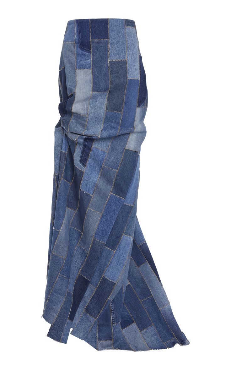 a long, highwaisted denim skirt made of patchwork fabric. the skirt is a beautiful shade of blue, and it has a relaxed and elegant fit. it would be perfect for a night out or a special occasion.