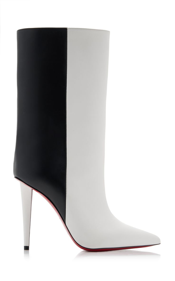 a pair of christian louboutin women's ankle boots are shown on a white background. the boots are a twotone design, with one half black leather and the other half white leather.  they have a pointed toe and a very high stiletto heel. the red lacquered sole is visible.